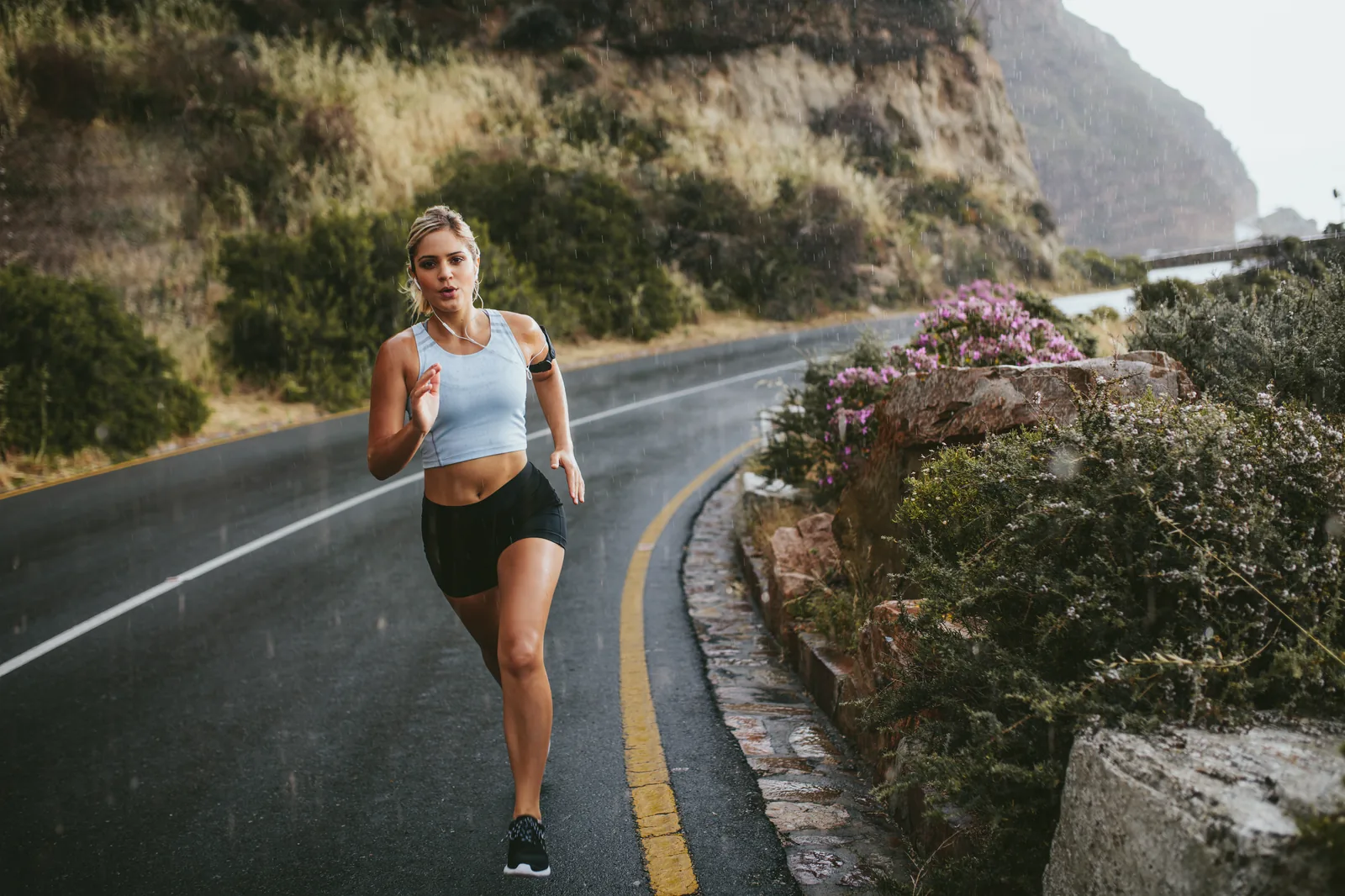 A runner getting back to steady miles on a quiet coastal road